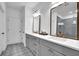 Chic bathroom with a double sink vanity, modern mirrors, and a glass-enclosed shower showcasing stylish tile work at 5320 Coltman Dr, Cumming, GA 30028