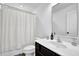 Bright bathroom with a shower/tub combo with white shower curtain, a vanity, and a toilet at 5320 Coltman Dr, Cumming, GA 30028