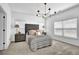 Cozy bedroom featuring plush carpet, neutral tones, and a stylish chandelier providing a relaxing retreat at 5320 Coltman Dr, Cumming, GA 30028