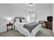 Cozy bedroom featuring a double bed, a small side table, and a desk with chair at 5320 Coltman Dr, Cumming, GA 30028
