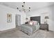 Bright bedroom with plush carpet, stylish chandelier, and a large window providing ample natural light at 5320 Coltman Dr, Cumming, GA 30028