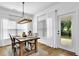 Bright dining area featuring modern chandelier and natural light, perfect for Gathering meals and entertaining at 5320 Coltman Dr, Cumming, GA 30028