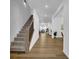 Inviting entryway showcasing wood floors, stairs, and an open floor plan at 5320 Coltman Dr, Cumming, GA 30028