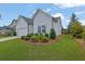 Well-maintained single-story home with a two-car garage, a long driveway, and lush landscaping at 5320 Coltman Dr, Cumming, GA 30028