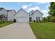 Traditional single-story home featuring a well-manicured lawn and a wide concrete driveway at 5320 Coltman Dr, Cumming, GA 30028