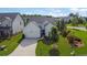 Charming single-Gathering home featuring white siding, a manicured lawn, and an attached two-car garage at 5320 Coltman Dr, Cumming, GA 30028