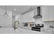 Kitchen island with stainless steel appliances, white cabinets, breakfast bar, and elegant gold hardware at 5320 Coltman Dr, Cumming, GA 30028