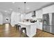 Stylish kitchen featuring stainless steel appliances, white cabinetry, and a center island with barstool seating at 5320 Coltman Dr, Cumming, GA 30028