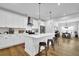 Modern kitchen with a large island, sleek appliances, and an open view to the dining area at 5320 Coltman Dr, Cumming, GA 30028