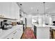 Modern kitchen with white cabinets, stainless steel appliances, a large island, and stylish backsplash at 5320 Coltman Dr, Cumming, GA 30028