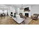 Cozy living room with a white brick fireplace, hardwood floors, and ample natural light at 5320 Coltman Dr, Cumming, GA 30028