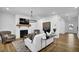 Stylish living room with a fireplace, hardwood floors, and seamless flow to the entryway at 5320 Coltman Dr, Cumming, GA 30028