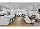 Bright open-concept space featuring a modern kitchen, dining area, and a comfortable living space at 5320 Coltman Dr, Cumming, GA 30028