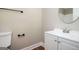 Bathroom showcasing modern fixtures, white vanity, round mirror and matching hardware at 5474 Post Road Pass, Stone Mountain, GA 30088