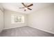 Light-filled bedroom with neutral carpet and a ceiling fan at 5474 Post Road Pass, Stone Mountain, GA 30088