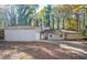 Inviting single-story home featuring stone accents and a large, private front yard surrounded by mature trees at 5474 Post Road Pass, Stone Mountain, GA 30088