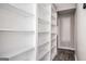 Hallway featuring built in shelving, wood floors and neutral colored walls at 5474 Post Road Pass, Stone Mountain, GA 30088