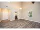 Bright living room featuring wood floors, a window, and a view into the kitchen at 5474 Post Road Pass, Stone Mountain, GA 30088