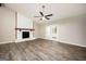 Spacious living room with fireplace, ceiling fan, and glass doors to the backyard at 5474 Post Road Pass, Stone Mountain, GA 30088