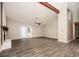 Bright living room featuring a painted fireplace, beam, ceiling fan and double doors leading to outdoor at 5474 Post Road Pass, Stone Mountain, GA 30088