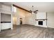 Open living space featuring a fireplace, beam, bar and modern wood flooring at 5474 Post Road Pass, Stone Mountain, GA 30088