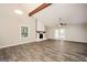 Open-concept living room features a fireplace, ceiling fan, and hardwood floors at 5474 Post Road Pass, Stone Mountain, GA 30088