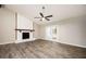 Bright living room featuring a painted fireplace, ceiling fan and double doors leading to outdoor at 5474 Post Road Pass, Stone Mountain, GA 30088