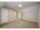 Spacious bedroom with neutral walls, carpet, and an open doorway at 60 Valley Rd, Covington, GA 30016