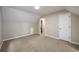 Spacious bedroom with neutral walls, carpet, and an ensuite bathroom at 60 Valley Rd, Covington, GA 30016