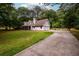 Spacious gray home with long driveway, two car garage, and expansive front yard at 60 Valley Rd, Covington, GA 30016