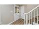 Bright foyer showcasing hardwood floors, a decorative glass door, and a staircase to the upper level at 60 Valley Rd, Covington, GA 30016