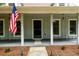Welcoming front porch with classic pillars and an American flag, a perfect outdoor space at 60 Valley Rd, Covington, GA 30016