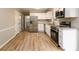 Bright kitchen features stainless steel appliances, white cabinets, and granite countertops at 60 Valley Rd, Covington, GA 30016