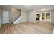 Open-concept living space featuring hardwood floors, a staircase, and seamless access to the kitchen at 60 Valley Rd, Covington, GA 30016