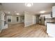 Open concept living room and kitchen with stainless appliances and wood floors at 60 Valley Rd, Covington, GA 30016