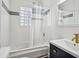 Bright bathroom with tub-shower combo, glass block window and modern sink at 1072 Piedmont Ne Ave # 101, Atlanta, GA 30309