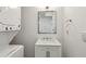 Modern bathroom featuring a stackable washer/dryer and a vanity with a square mirror at 1072 Piedmont Ne Ave # 101, Atlanta, GA 30309