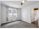 Well-lit bedroom with plush carpet, a window, and an open doorway at 1072 Piedmont Ne Ave # 101, Atlanta, GA 30309