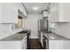 Modern kitchen featuring stainless steel appliances, granite countertops, and white cabinetry at 1072 Piedmont Ne Ave # 101, Atlanta, GA 30309