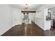 Spacious living room with hardwood floors, leading to a modern kitchen and open staircase at 1072 Piedmont Ne Ave # 101, Atlanta, GA 30309