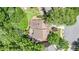 Aerial view of home with mature trees and lush green yard at 1600 Heritage Trl, Roswell, GA 30075