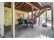 Covered back deck with outdoor grill, dining set, and stairs leading to the backyard at 1600 Heritage Trl, Roswell, GA 30075