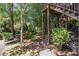 Secluded backyard featuring a wooden deck, stairs, lush trees, and peaceful ambiance at 1600 Heritage Trl, Roswell, GA 30075