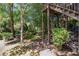 Landscaped backyard featuring a deck, mature trees, and a serene atmosphere at 1600 Heritage Trl, Roswell, GA 30075