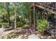 View of backyard with trees, foliage and deck with wooden staircase at 1600 Heritage Trl, Roswell, GA 30075