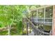 Elevated wooden deck and staircase overlooks the lush backyard at 1600 Heritage Trl, Roswell, GA 30075