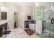 Bright bathroom featuring a glass enclosed shower, soaking tub and tile flooring at 1600 Heritage Trl, Roswell, GA 30075