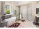 Bathroom with soaking tub, glass-enclosed shower and tiled floor at 1600 Heritage Trl, Roswell, GA 30075