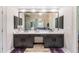 Bathroom featuring double sinks, granite countertop and dark wood cabinets at 1600 Heritage Trl, Roswell, GA 30075