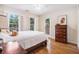 Bedroom featuring bright windows, wood flooring, ceiling fan and side tables at 1600 Heritage Trl, Roswell, GA 30075
